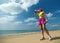 Fitness woman drinking water after running at beach.