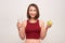 Fitness woman eating apple wearing measuring tape. Fit sporty multicultural Asian