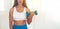 Fitness woman exercising cross fit holding dumbbells. Fitness instructor in the sport room background