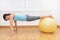 Fitness woman in gym on pilates ball. Young woman doing exercise on fitness ball.