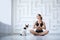 Fitness woman indoors doing relaxation exercises. Yoga with pets