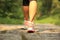 Fitness woman legs hiking on trail