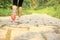 Fitness woman legs hiking on trail