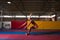 Fitness Woman Performing a Long Jump In Gym