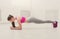 Fitness woman plank training at white background indoors