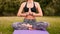 Fitness woman practicing yoga outdoors in park