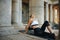 Fitness woman relaxing on a training mat after workout with eyes closed. Female athlete doing fitness training sitting on yoga mat