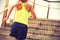 Fitness woman runner running on seaside stone stairs