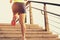 Fitness woman runner running on seaside stone stairs