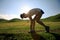 Fitness woman runner running on sunset grassland trail