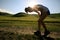 Fitness woman runner running on sunset grassland trail