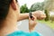 Fitness woman runner setting up smart watch before running. Outdoor exercise activities