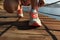 Fitness woman runner tying shoelace at seaside boardwalk