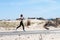 Fitness woman running on beach