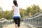 Fitness woman running at city footbridge