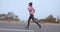 Fitness woman running on countryside road