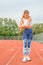 Fitness woman on running track has elbow pain during workout