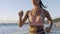 Fitness, woman running and workout on beach in summer sunshine exercise, runner training and sports wellness. Athlete