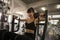 fitness woman in sportswear exercising building muscles Chest , biceps , arm with push machine in sport gym. workout , training ,