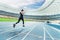 Fitness woman in sportswear running on running track stadium