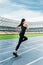 Fitness woman in sportswear running on running track stadium