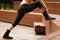 Fitness woman stretching legs before training outdoors