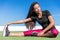 Fitness woman stretching one leg toe-touch stretch