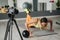 Fitness woman trainer recording video on camera while training at gym indoor. Concept Lifestyle influencer sport and