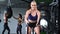 Fitness woman training with battle ropes intense workout slow motion. Medium shot on RED camera