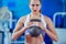 Fitness woman training by kettlebell.