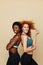 Fitness Women. Beautiful Ethnic Girls Portrait. Sporty African Brunette And Caucasian Redhead Posing On Beige Background.