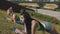 Fitness women doing plank exercises in morning park on yoga mat in slow motion