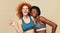 Fitness Women. Ethnic Girls Portrait. Smiling African Brunette And Caucasian Redhead Posing On Beige Background. Sport For Active