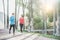 Fitness young couple running outdoor with palms in background - Sporty happy people training in tropical place - Healthy lifestyle