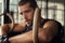 Fitness young man leaning and resting at gym