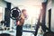 Fitness young Man lifting barbells looking focused working out i