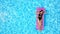 Fitted pretty girl in bikini chilling on inflatable pink mattress in swimming pool. Shaped woman in swimsuit tanning