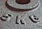 Five & x28;5& x29; kg weight disk plate close up. Metallic texture gray dark background