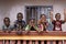 Five African Children Greeting Bypassers From A Colonial House Balcony