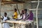 Five African youngsters smiling in a stall