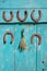 Five antique rusty horseshoe and wheat ears bunch on wall