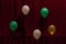 Five balloons of different colors on a red background. For decoration design of the holiday.