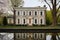 five-bay georgian stone facade reflected in a pond