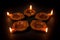 Five beautiful Handmade Designer Clay Lamps in a row with burning wick