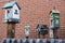 Five birdhouses with a brick wall background