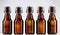 Five blank glass bottles of beer