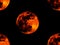 Five bright full orange red blood moon on black background wallpaper with repeated figures.