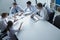 Five business people having a business meeting at the table in the office