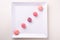 Five candy canes sweets in form of juicy berries on white plate on white background top view