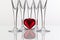 Five champagne glasses and red heart
